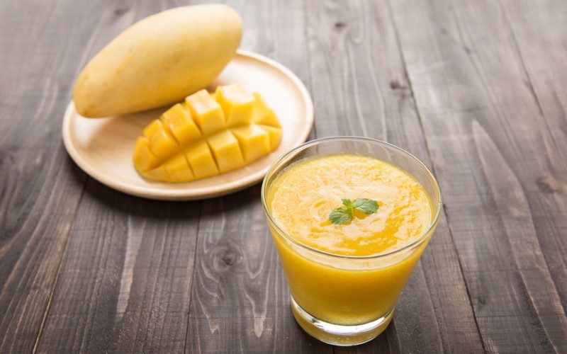 mango smoothie on wooden table